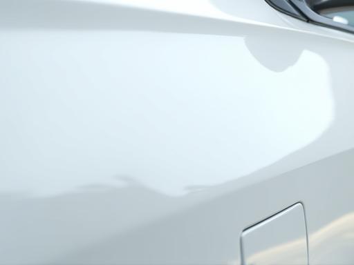 White sedan exterior after premium waxing, showing a slick surface and high shine.