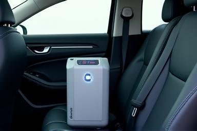 An ozone generator machine placed inside a car cabin with doors closed.